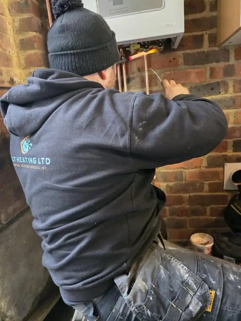 Heating engineer working on a boiler installation.
